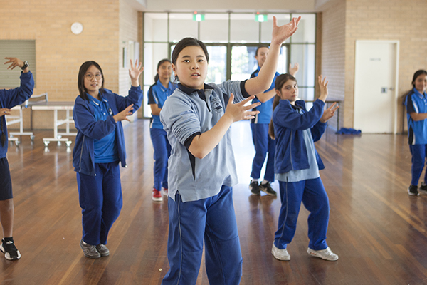students dancing at school hall